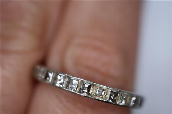 A white metal and square cut diamond set full eternity ring, size O/P.